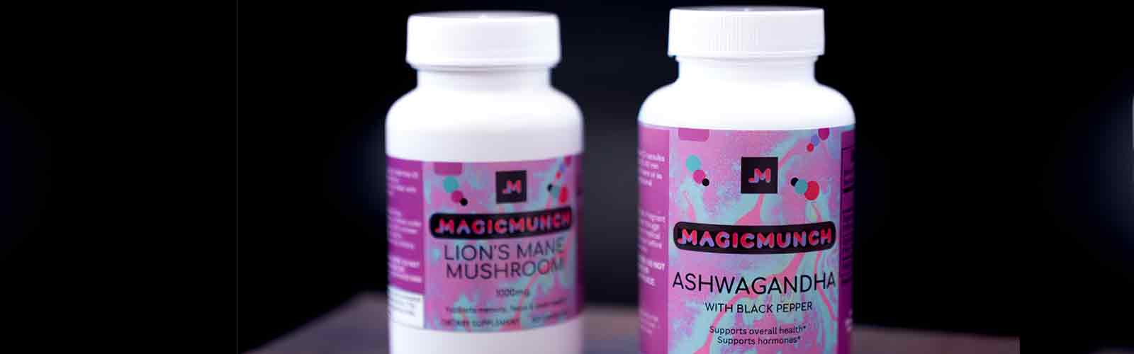 Magic Munch Lions Mane and Ashwaganda supplement bottles placed next to each other with a black background