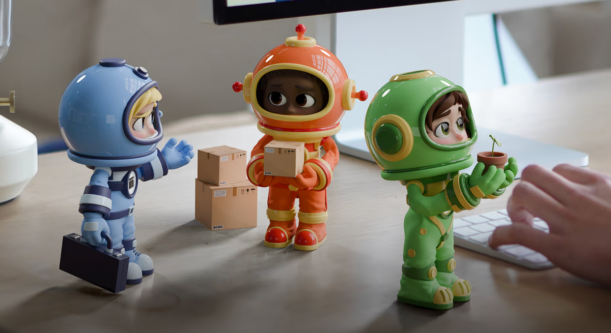 Three colorful astronaut figurines stand on a desk in a real indoor setting, with a person's hand visible at the right edge near a keyboard. The figurines are blue, orange, and green, each with a helmet and different accessories, including boxes and a small plant. These are Sintra's AI agents animations.